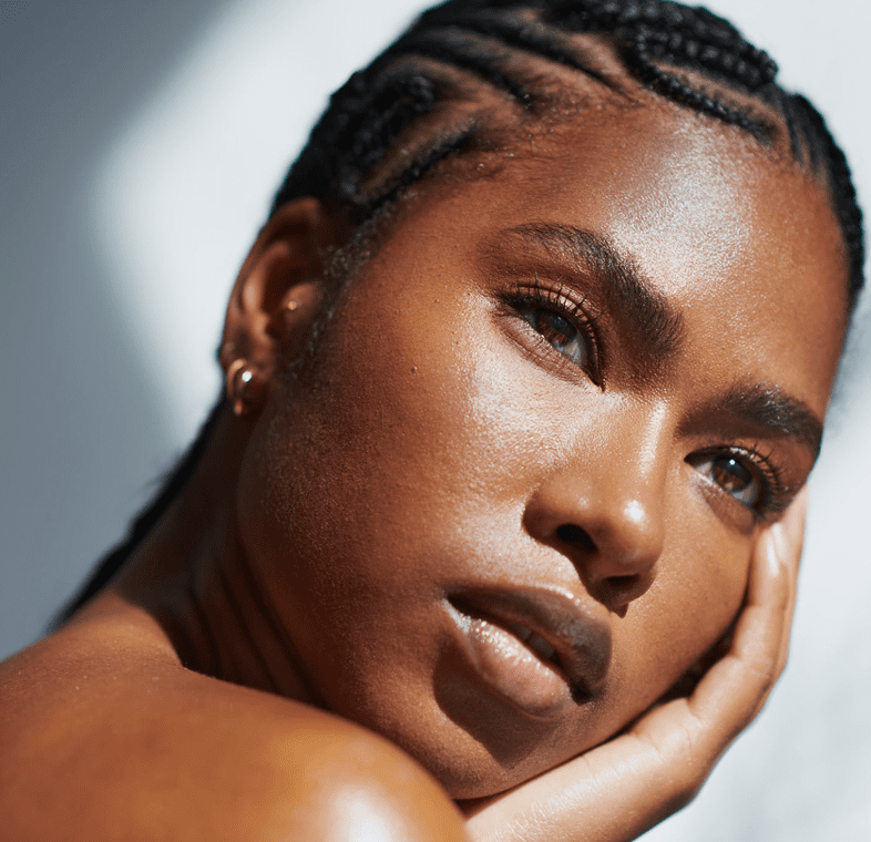 Woman with braided hair, thoughtful expression