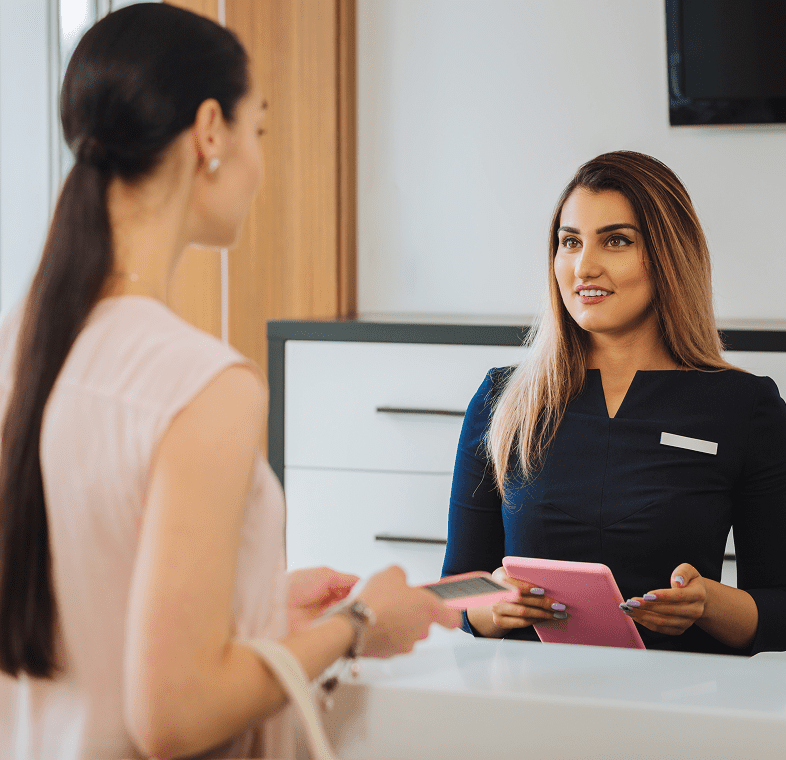 Woman checking in at hotel reception