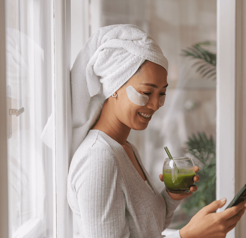 Self-care routine with eye masks and phone