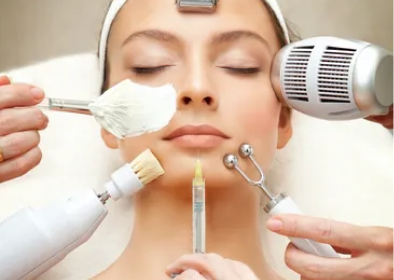 Multiple beauty devices used on woman's face