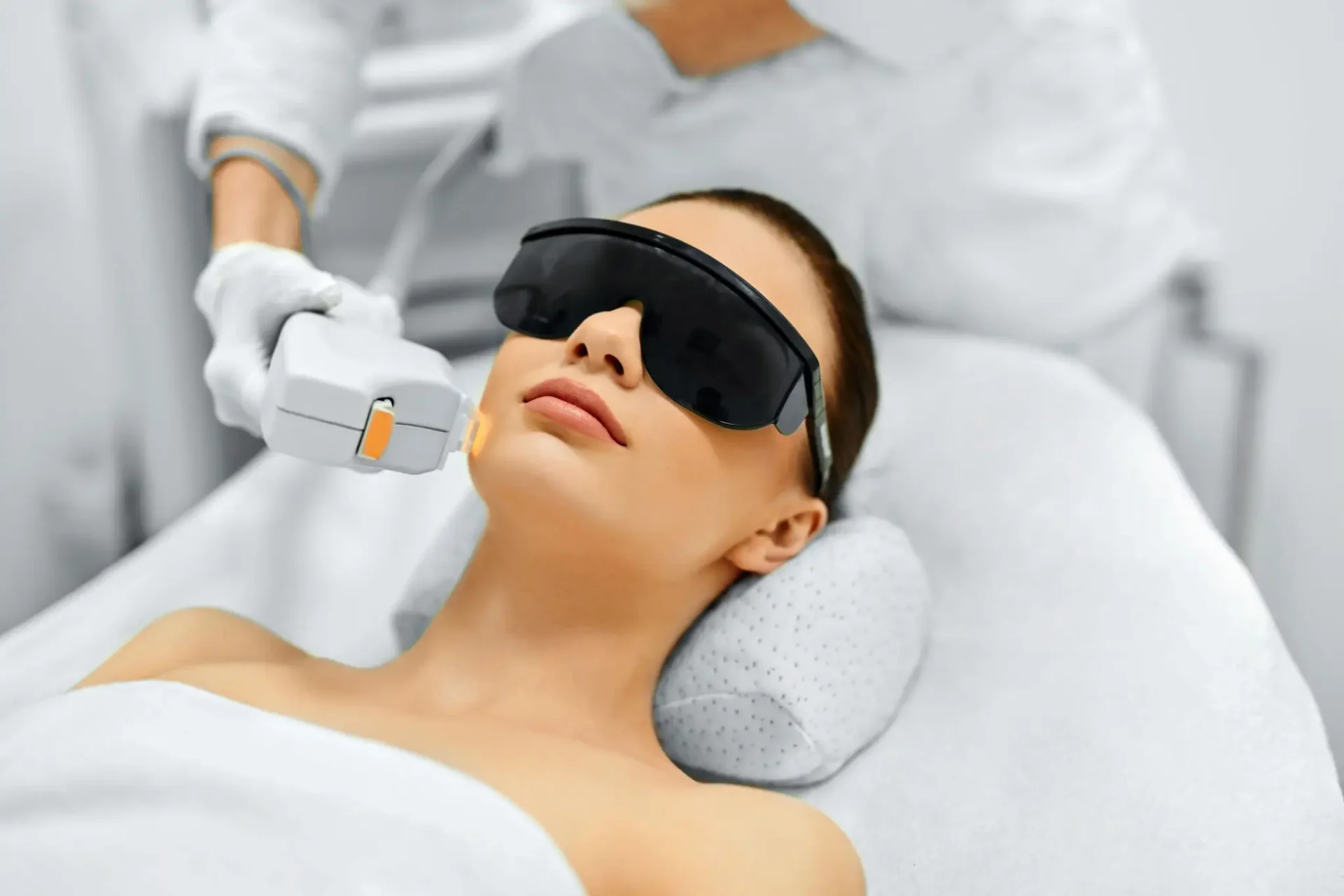 Woman receiving laser skincare treatment